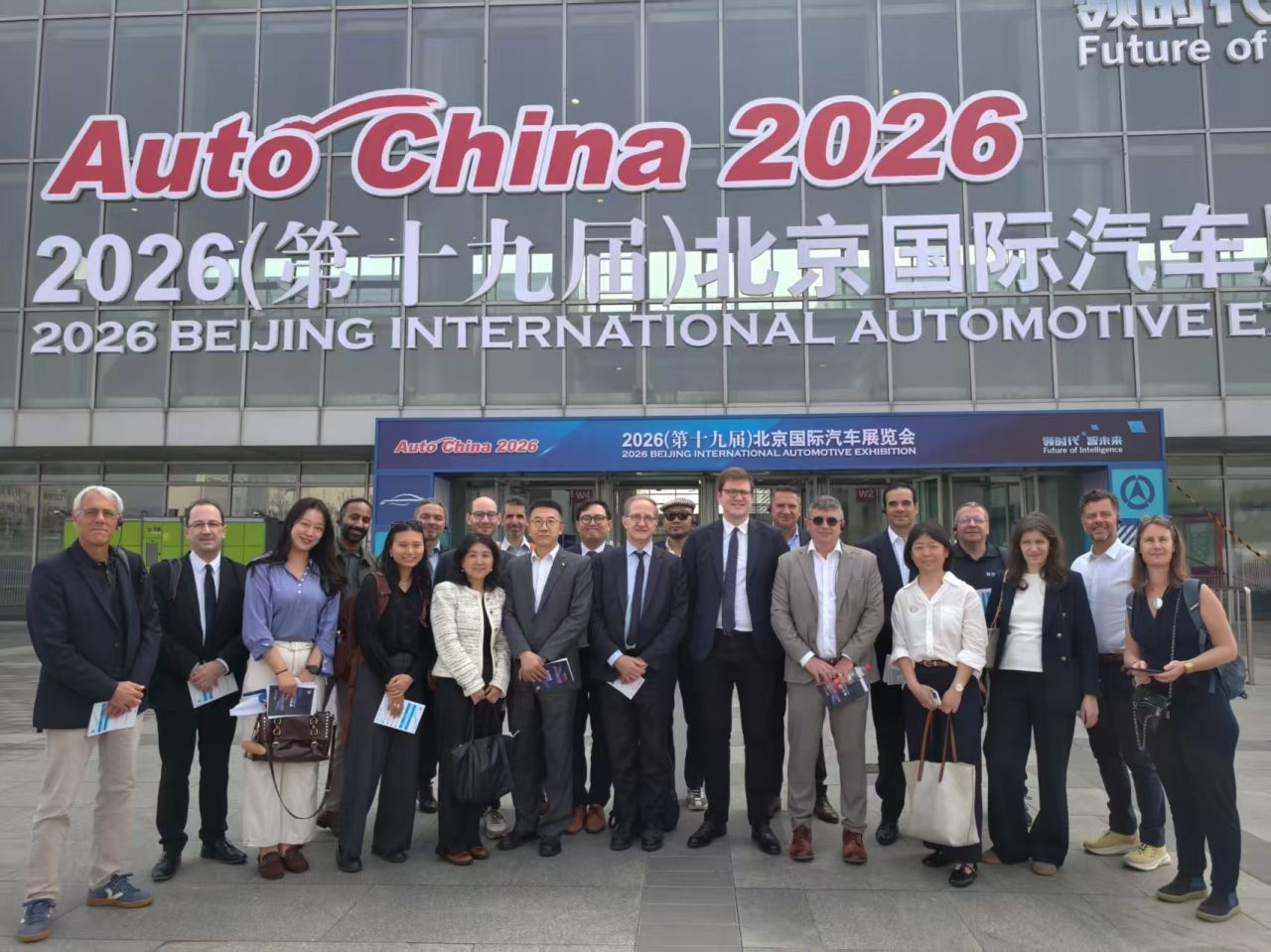 Group of participants in front of the Auto China 2026 exhibition in Beijing.